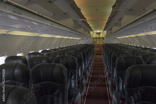 Walkway in the aircraft. Row of black seat. Journey with aircraft.