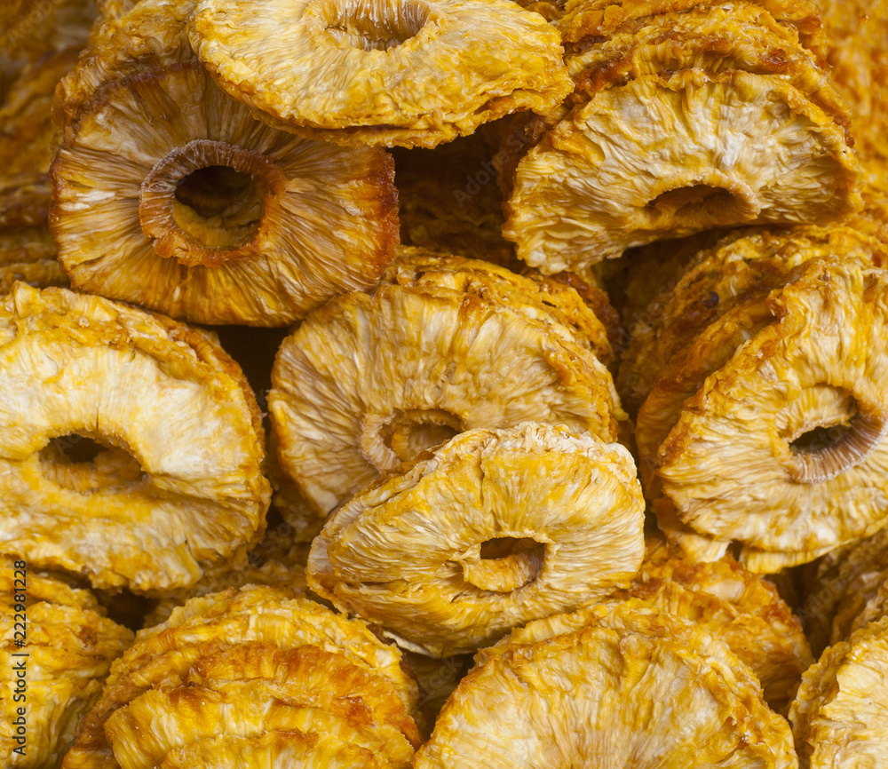 dried ananas fruits on a pile on a food market, coloful dried fruits, dried fruits dried ananas fruits on a pile on a food market, coloful dried fruits, dried fruits
