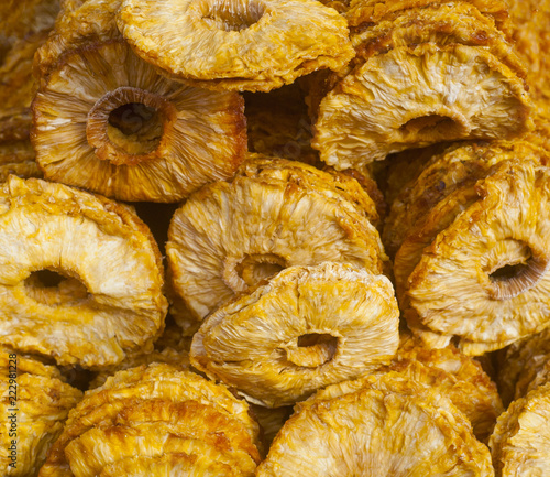 dried ananas fruits on a pile on a food market, coloful dried fruits, dried fruits