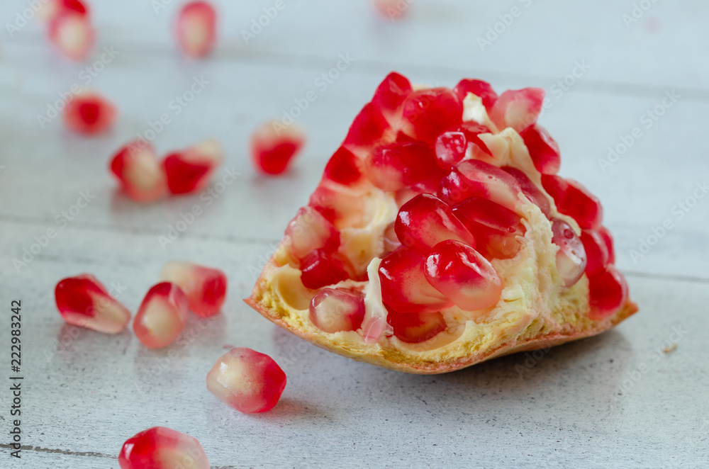 Sliced pomegranate and grains on wooden table, Sliced pomegranate and grains on wooden table,