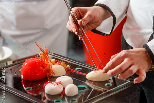 Fototapeta Naklejka Na Ścianę i Meble -  Putting cherry at yogurt sphere
