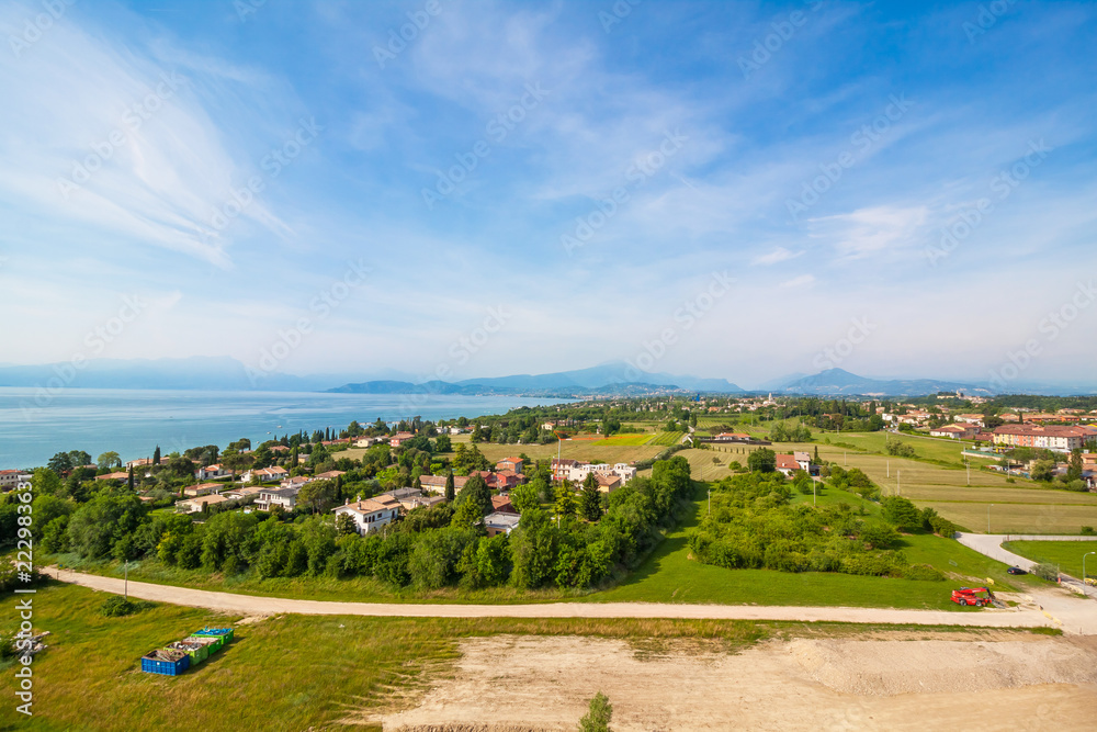 Garda Lake and high mountain in background. View from observation desk in GardaLand, Lombardy, Italy