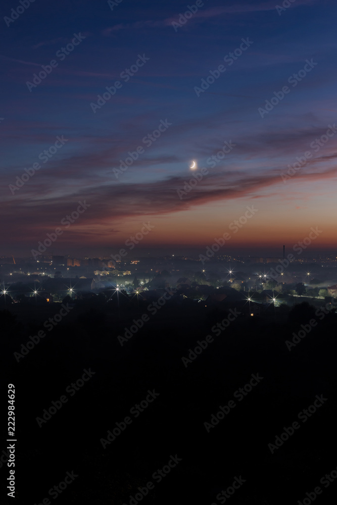 Aerial view on Ivano-Fankivsk city after the sunset with the moon