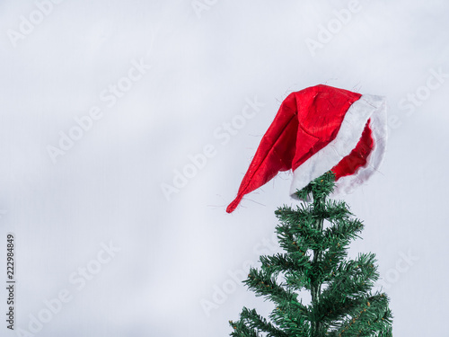 Red Hat on Christmas tree and white background,