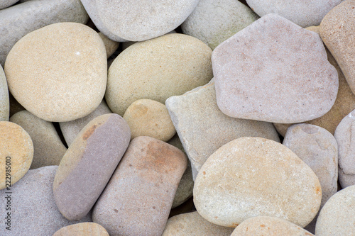 Several round beautiful smooth stones on the seashore