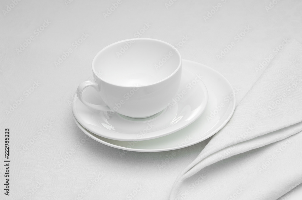 ceramic white cup with napkin on white background ceramic white cup with napkin on white background