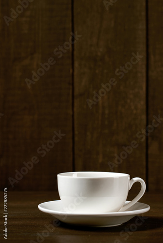 one classic coffee or tea cup on a dark wooden background
