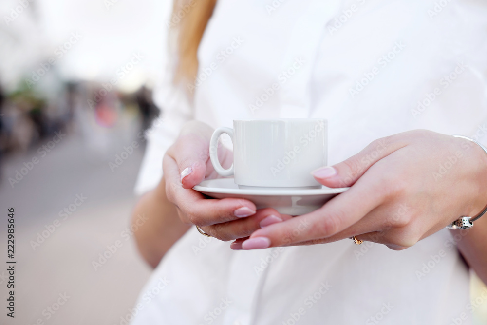 holding cup of coffee in the open air place or observation deck. Old town on background. Concept love morning. holding cup of coffee in the open air place or observation deck. Old town on background. Concept love morning.