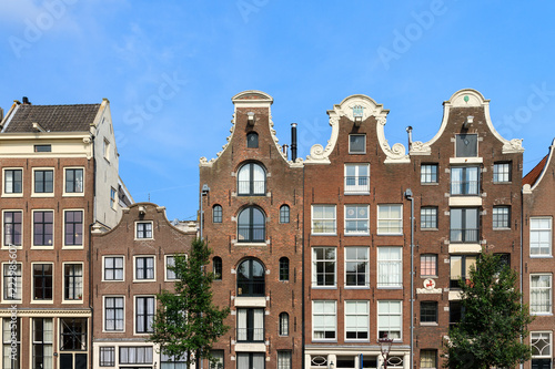 Beautiful view of the canal houses at the Prinsengracht canal in Amsterdam, the Netherlands, on a summer day with blue sky 