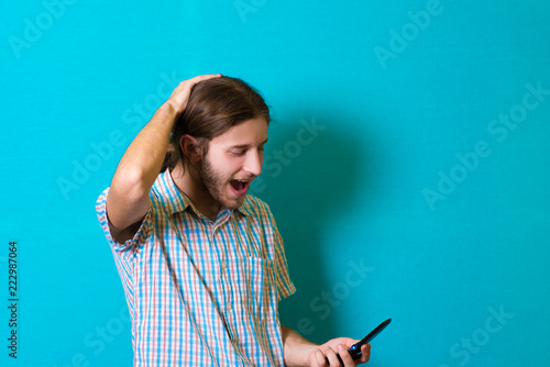 Young man on the phone shocked