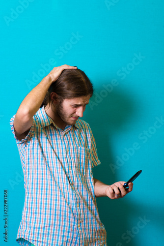 Young man on the phone shocked