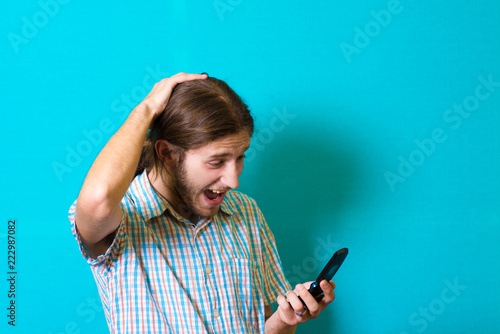 Young man on the phone shocked