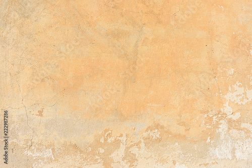 texture of old peeling yellow plaster