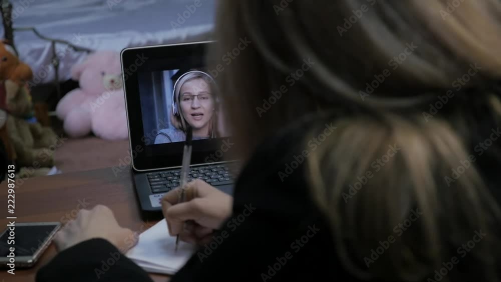 Woman video conferencing with tutor on laptop at home. Distance education concept. on-line education at home. slow motion Woman video conferencing with tutor on laptop at home. Distance education concept. on-line education at home. slow motion