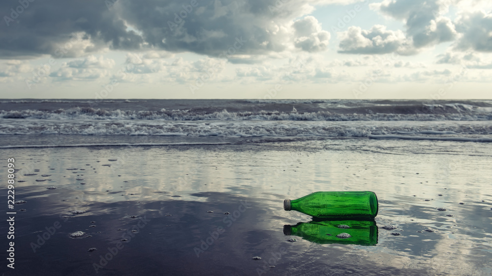 A glass bottle is thrown out to the seashore A glass bottle is thrown out to the seashore