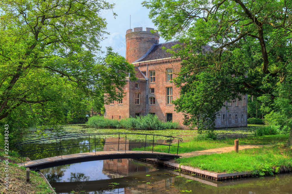 Beautiful view with reflection of castle Loenersloot in the Netherlands in summer