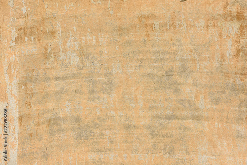 texture of old peeling yellow plaster