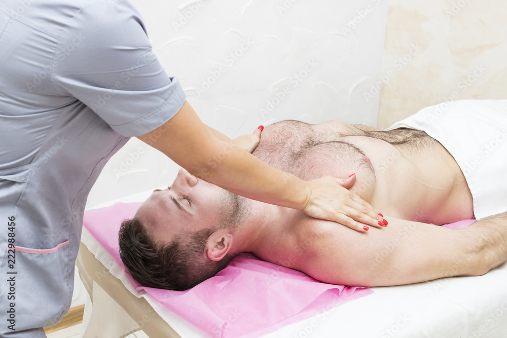 Man doing sports massage at the massage parlor Man doing sports massage at the massage parlor