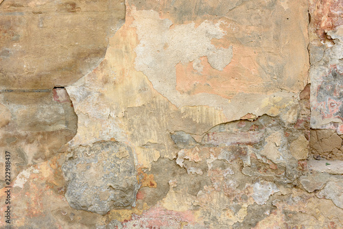 texture of old peeling yellow plaster