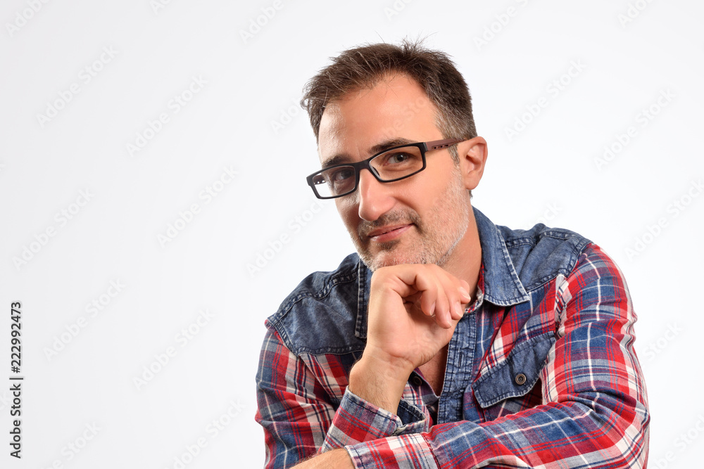 Modern man interesting with hand on chin looking straight ahead Modern man interesting with hand on chin looking straight ahead