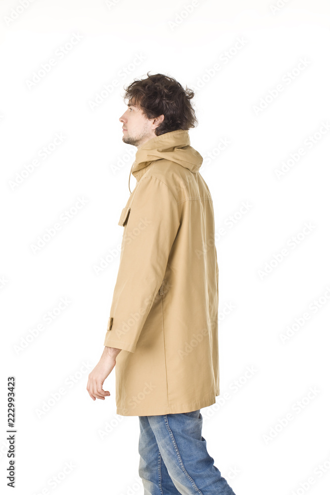 Man in raincoat making step