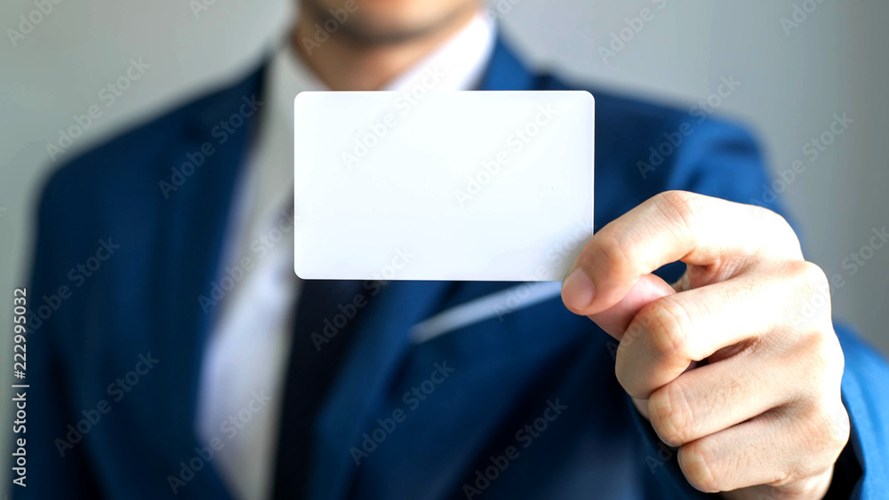 businessman holding and showing empty business card or name card - business concept businessman holding and showing empty business card or name card - business concept