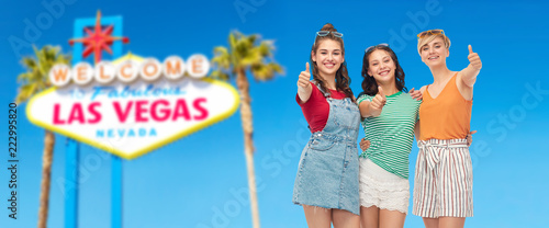 Photography friendship and people concept - group of happy teenage girls showing thumbs up o
