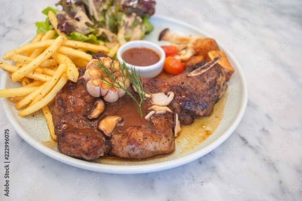 T-Bone steak with fresh vegetable salad and French fries. T-Bone steak with fresh vegetable salad and French fries.
