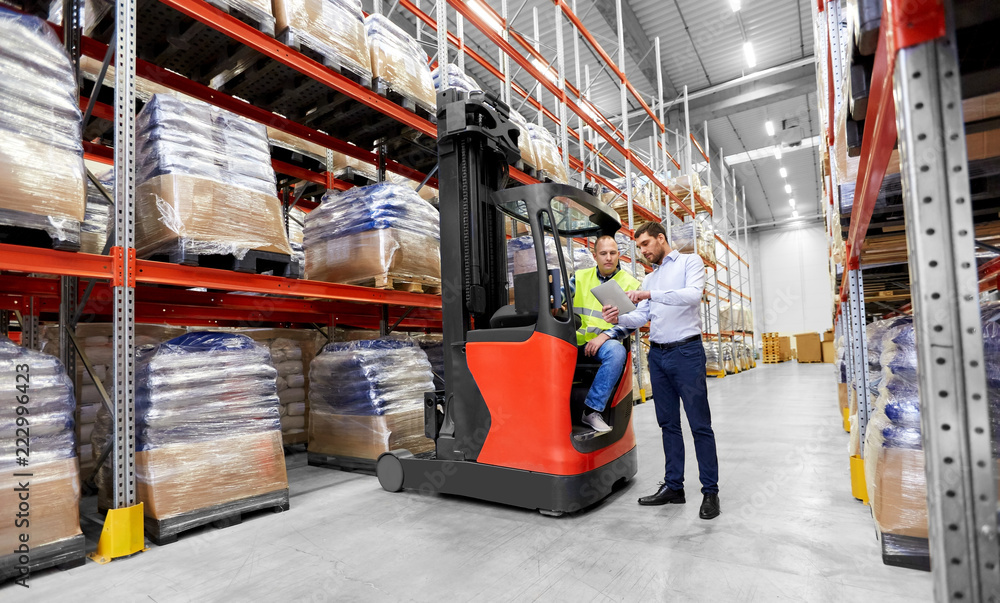 logistic business, shipment and people concept - warehouse worker and businessman with tablet pc computer and tablet pc computer logistic business, shipment and people concept - warehouse worker and businessman with tablet pc computer and tablet pc computer