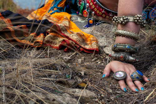 Tribal style jewelry on the hands of close-ups, iron rings and bracelets