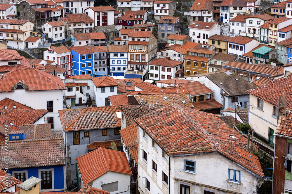 Spain, Asturias, Cudillero, Cuideiru: Colorful traditional houses with red roof tops and narrow alleys in the city center of the small Spanish village. Legend says it was founded by the Vikings.