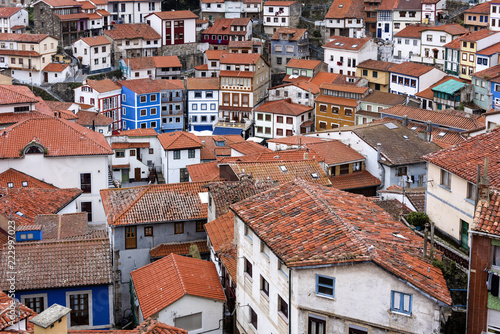 Spain, Asturias, Cudillero, Cuideiru: Colorful traditional houses with red roof tops and narrow alleys in the city center of the small Spanish village. Legend says it was founded by the Vikings.