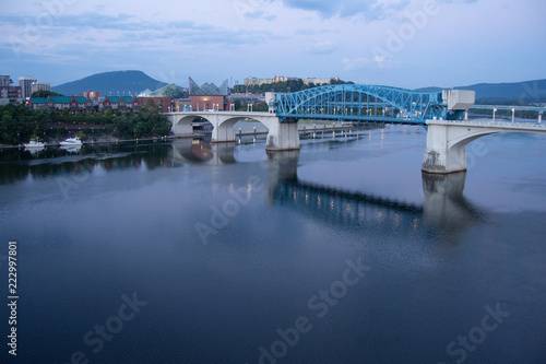 Blue bridge across a river at sunrise, leading to downtown Chattanooga, Tennessee