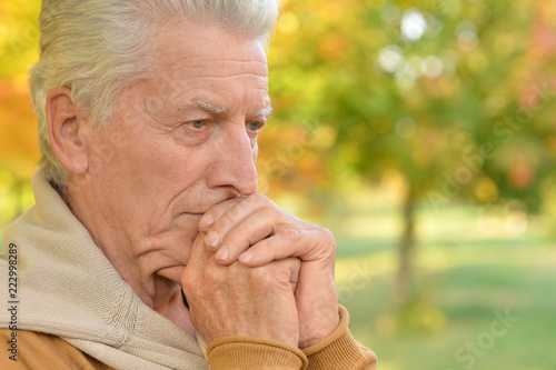 Portrait of senior man posing in park