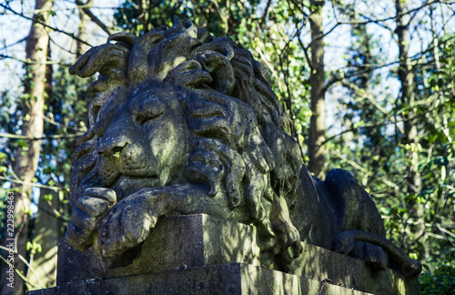 Tomb with statue of lion on Highgate Cemetery photo