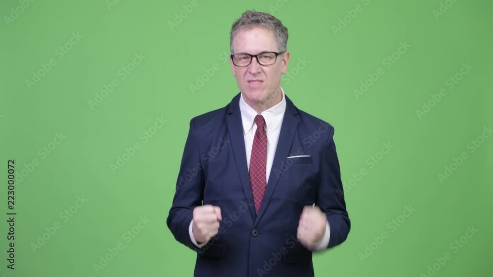 Studio shot of angry mature businessman pulling his hair out Studio shot of angry mature businessman pulling his hair out