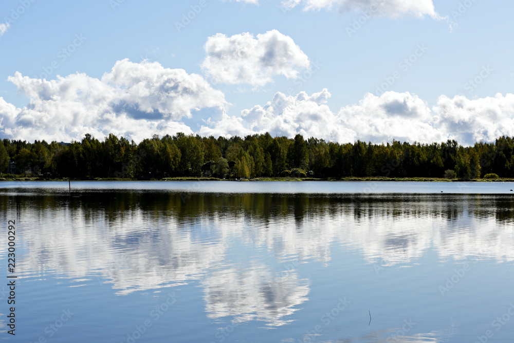Autumn sky reflects on a lake surface Autumn sky reflects on a lake surface