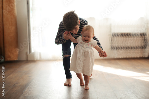 Cute big brother teen help him sister toddler