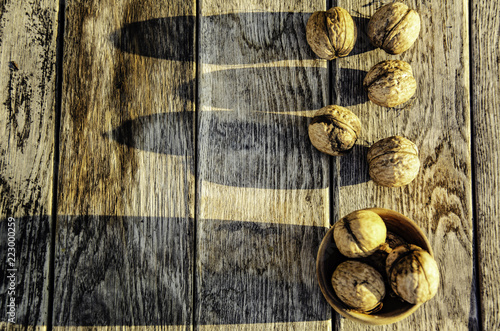 Harvest of a walnut in a garden on a wooden background.