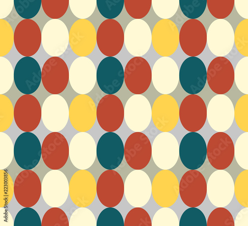 Seamless patter made of retro colored oval abstract geometry shapes in vintage colors of red, tan, blue, yeelow - orange on grey background, Easter egg imitation