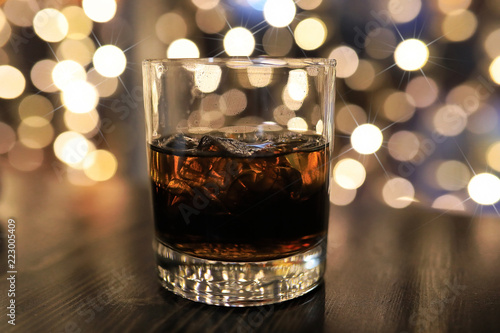 glass of cold alcohol drink with ice on table