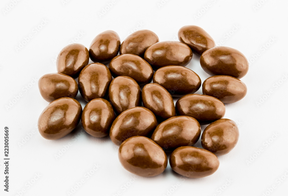 Chocolate covered nuts isolated on white background - Close up horizontal image with space for text Chocolate covered nuts isolated on white background - Close up horizontal image with space for text