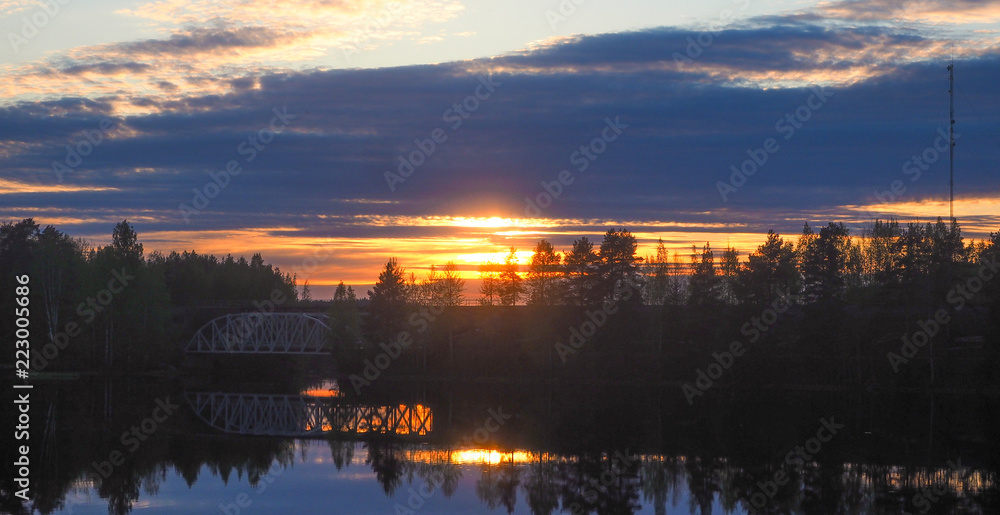 beautiful view of a bridge at lake päijänne at sunset
