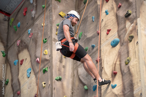 Man climber on artificial climbing wall