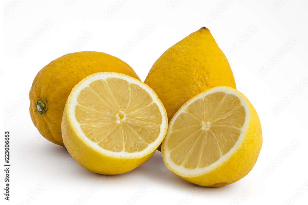Composition of fresh ripe lemons, delicious citrus fruit isolated on white background. One cutted in half Composition of fresh ripe lemons, delicious citrus fruit isolated on white background. One cutted in half