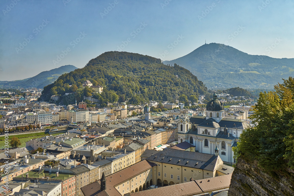 HDR beautiful landscape view of the city of Salzburg in Austria with a cathedral and mountains in the background.