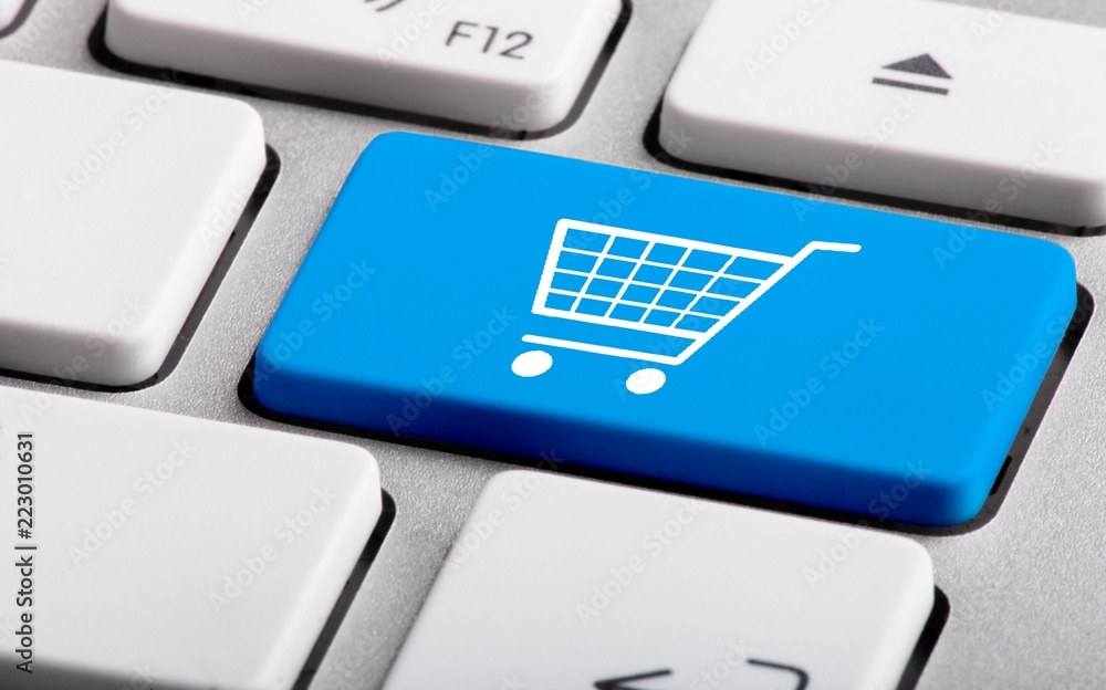 Blue Bottom with Shopping Trolley on a Laptop - Close Up Blue Bottom with Shopping Trolley on a Laptop - Close Up