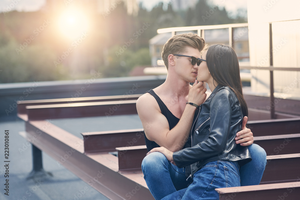 interracial hot sexy couple kissing on urban roof with sunlight foto de  Stock | Adobe Stock
