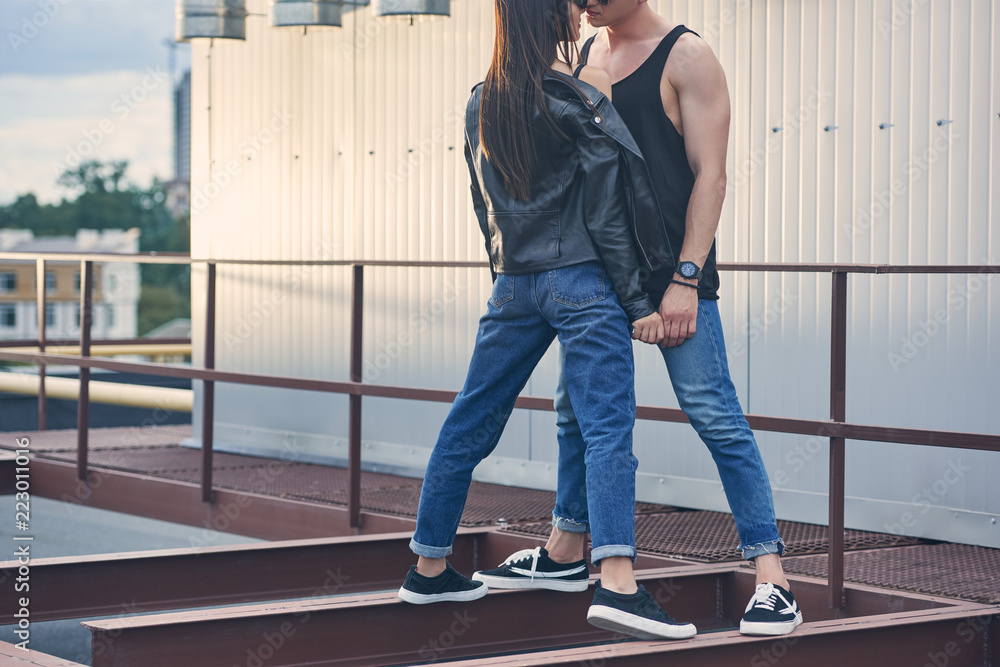 cropped view of sexy couple flirting on urban roof