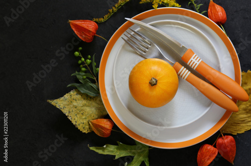 autumn table setting with pumpkin and flowers
